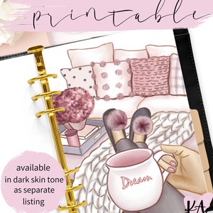 May include: A printable planner page featuring a cozy illustration of a person relaxing on a couch with pillows, a mug that says "Dream", and fuzzy slippers. The page is designed for a standard size planner.