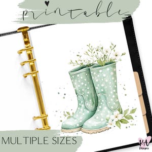 May include: Printable planner sticker featuring a pair of green rain boots with white polka dots and a bouquet of white flowers. The sticker is designed for use in a planner or journal.