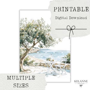 May include: Watercolor print of a coastal scene with an olive tree, a white table, and chairs. The print includes the text "PRINTABLE Digital Download" and "MULTIPLE SIZES". The artwork features a serene view of the sea.