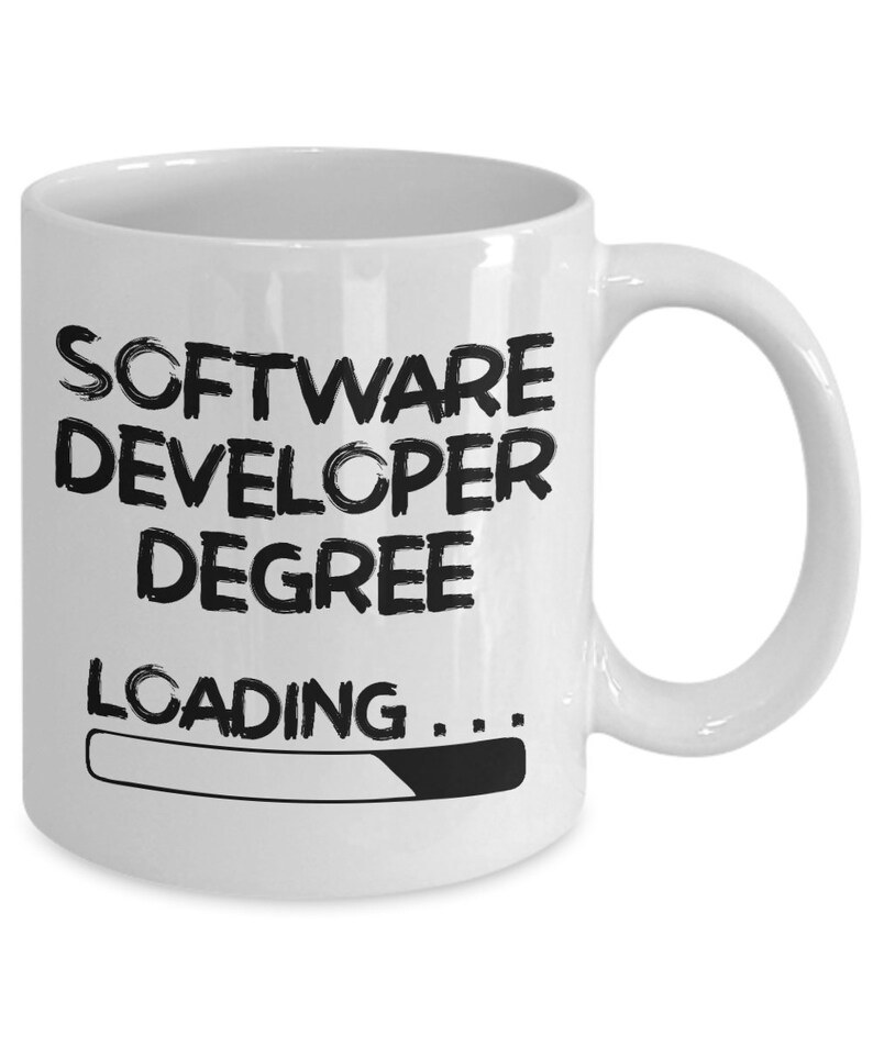 May include: White ceramic coffee mug with black text that reads "Software Developer Degree Loading..." with a progress bar underneath.