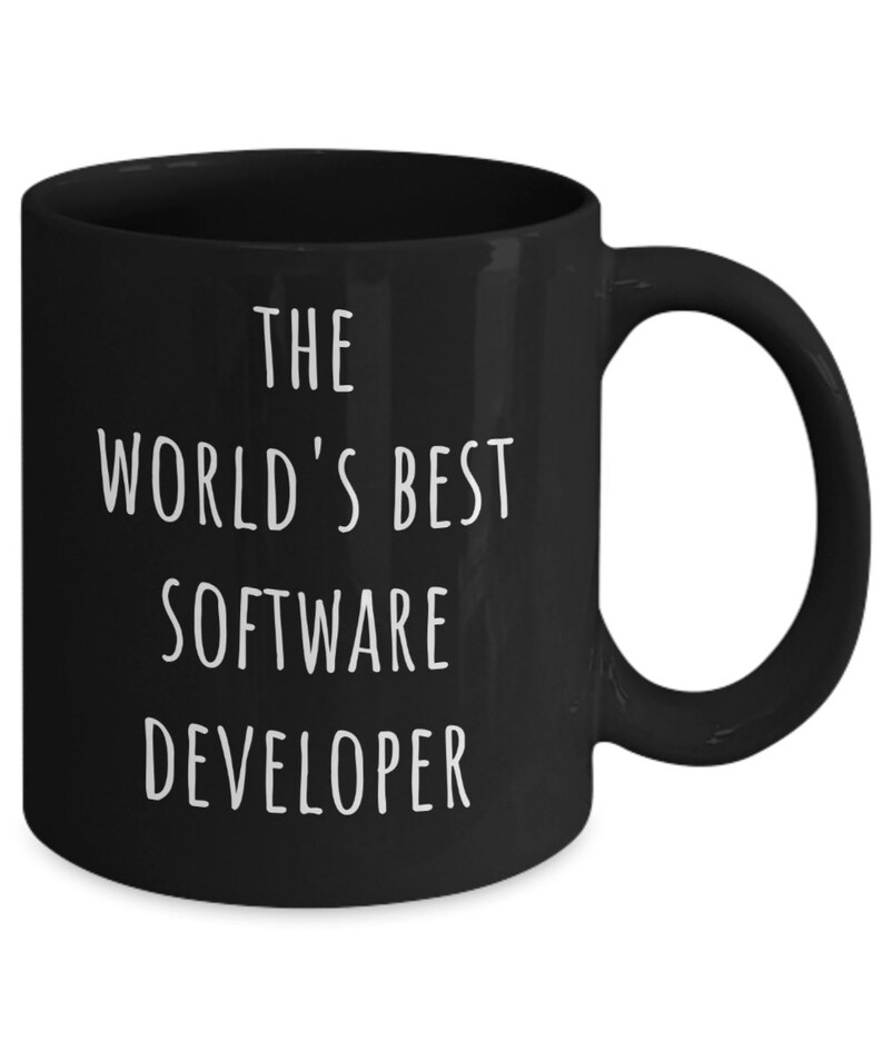 May include: A black ceramic mug with the text "THE WORLD'S BEST SOFTWARE DEVELOPER" in white. The mug has a curved handle and a glossy finish. A great gift for a software developer.