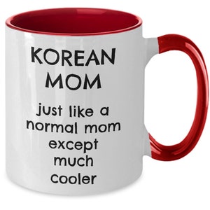 May include: White ceramic coffee mug with a red rim and handle. The mug has black text that reads "KOREAN MOM just like a normal mom except much cooler".