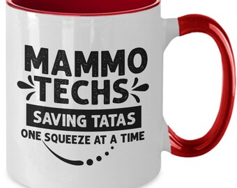 May include: White ceramic coffee mug with a red rim and handle. The mug has black text that reads "Mammo Techs Saving Tatas One Squeeze at a Time".