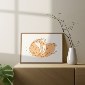 May include: A framed print of a line drawing of a clownfish with an orange and white color scheme. The fish is depicted in a single line with a simple, minimalist style.