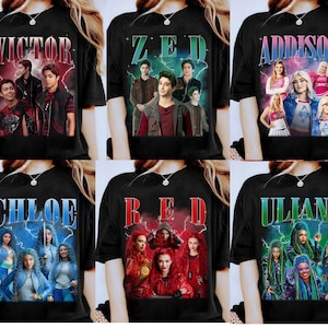 May include: Black t-shirts featuring various character names and images. The shirts display the names "VICTOR", "ZED", "ADDISON", "CHLOE", "RED", and "ULLIANA" in stylized fonts, each accompanied by a group of character portraits.