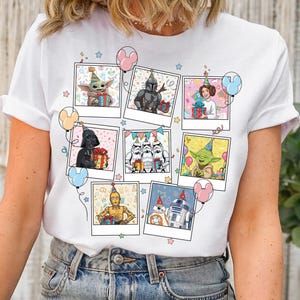 May include: White t-shirt featuring a collage of Star Wars characters in birthday party settings. The characters include Yoda, Darth Vader, and others, each in a Polaroid-style frame with balloons and confetti. A fun and festive design for fans.