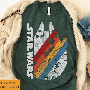 May include: Heather forest green Bella T-shirt with a colorful graphic of the Millennium Falcon from Star Wars. The graphic features red, orange, yellow, and blue stripes. The words "STAR WARS" are printed vertically on the left side of the shirt.