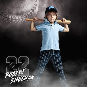 May include: A young boy wearing a blue and black baseball cap holds a wooden baseball bat over his shoulder. He is wearing a light blue collared shirt and plaid pants. The background is a dark gray with a large baseball and smoke.