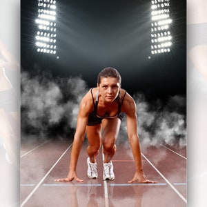 May include: A female athlete in a black sports bra and shorts is in a starting position on a red running track. The track is under stadium lights and there is smoke in the air.