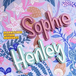 May include: Two personalised names, "Sophie" and "Henley", are displayed in a 3D style on a colourful floral background. The names are in different colours, with "Sophie" in pink and "Henley" in light blue.