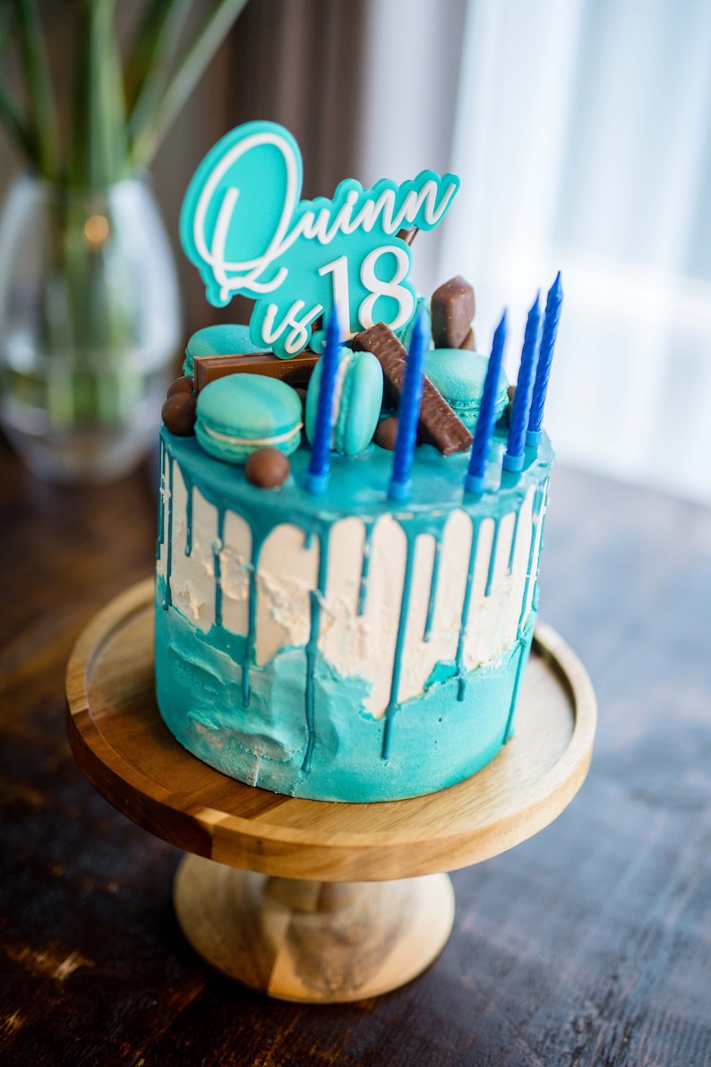 image of a aqua cake topper saying Quinn is 18
