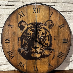 May include: A wooden clock with Roman numeral markings and a black and white tiger design. The clock face is brown with a dark wood grain.