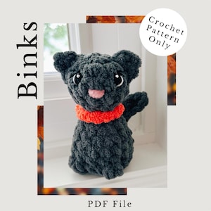 May include: A handmade, dark gray crochet cat with a bright orange collar. The cat has large, white-rimmed eyes, a pink nose and mouth, and a friendly expression. The image includes the text "Binks", "Crochet Pattern Only", and "PDF File".