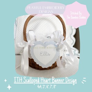 May include: A white scalloped heart banner with blue gingham trim and the name "Ellis" embroidered in the center. The banner is in a wicker basket with white fabric and ribbon. The banner is available in sizes 4x4 inches, 5 inches, 6 inches, 7 inches, and 8 inches.