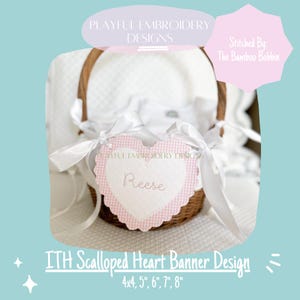 May include: Pink and white scalloped heart banner with the name "Reese" embroidered on it. The banner is hanging from a wicker basket. The banner is available in sizes 4x4 inches, 5 inches, 6 inches, 7 inches, and 8 inches.