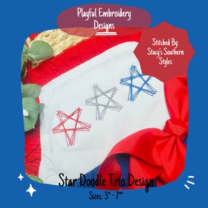 May include: A white fabric with three embroidered stars in red, blue, and grey. The stars are in a doodle style. The fabric is surrounded by red and blue ribbon. The text "Star Doodle Trio Design" and "Sizes: 3"-7"" is below the stars.