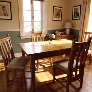 May include: A wooden dining table and four chairs in a bright room. The rectangular table is surrounded by chairs with patterned seats. Artwork and a window are visible, creating a warm and inviting atmosphere.