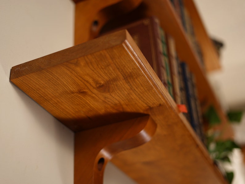 Detail shot of bottom shelf corner showing the grain of the wood.