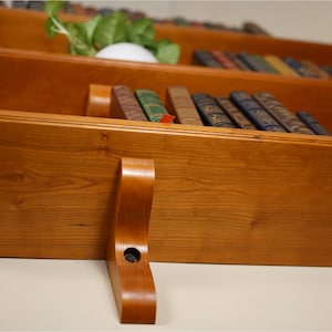 Detail shot of shelves from the bottom lefthand corner showing off the grain of the wood.
