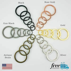 May include: Assortment of key rings in various finishes, including black, gun black, antique brass, silver, gold, and rose gold.  Each key ring is a simple circle shape.