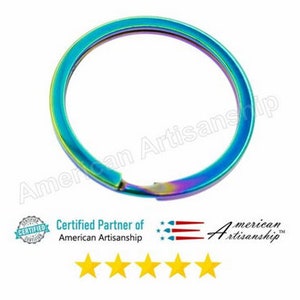 May include: A rainbow iridescent key ring made of metal. The key ring is a single, continuous loop.
