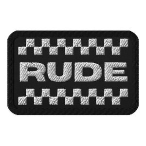 May include: Black embroidered patch with white checkered borders and the word "RUDE" in white lettering.