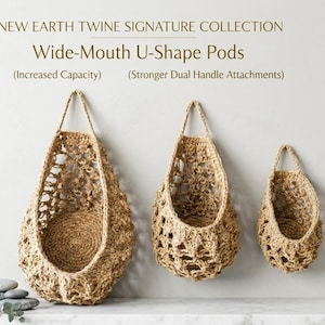 May include: Three woven, wide-mouth U-shape pods in varying sizes, suspended from a neutral-coloured wall. The pods are made of natural twine, featuring open weave patterns and sturdy handles. The text reads "New Earth Twine Signature Collection".