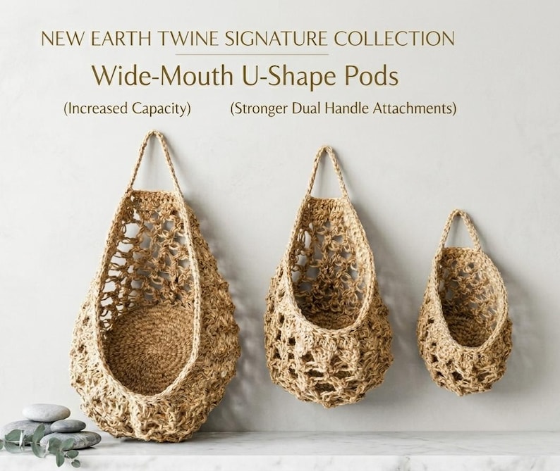 May include: Three woven, wide-mouth U-shape pods in varying sizes, suspended from a neutral-coloured wall. The pods are made of natural twine, featuring open weave patterns and sturdy handles. The text reads "New Earth Twine Signature Collection".