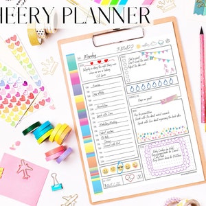 May include: A white planner with a colorful striped border and a black and white illustration of a heart, a sun, and a cloud. The planner has a section for Monday, March 14, 2022, and includes space for daily tasks, notes, and a to-do list. The text "God is good. Don't sweat the small stuff. About the big one." is written in a pink box on the planner.