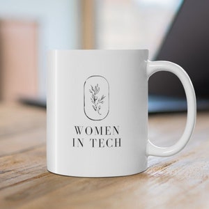 May include: White ceramic mug with a black and white floral design and the text "Women in Tech".