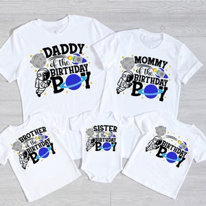 May include: Set of five white t-shirts with astronaut and space-themed designs. The shirts say "Daddy of the Birthday Boy", "Mommy of the Birthday Boy", "Brother of the Birthday Boy", "Sister of the Birthday Boy", and "Birthday Boy".