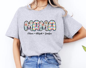 May include: Gray t-shirt with the word "MAMA" in colorful checkered and floral letters. The names "Oliver", "Alijah", and "Jenifer" are written below the word "MAMA".