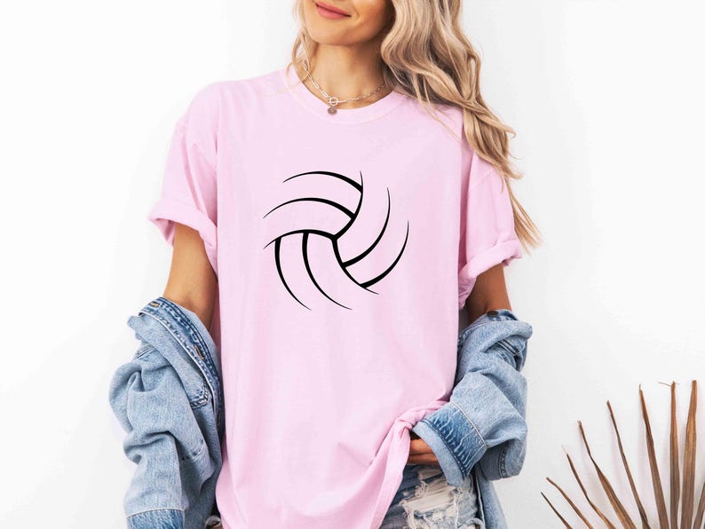 May include: A pink t-shirt with a black volleyball graphic.