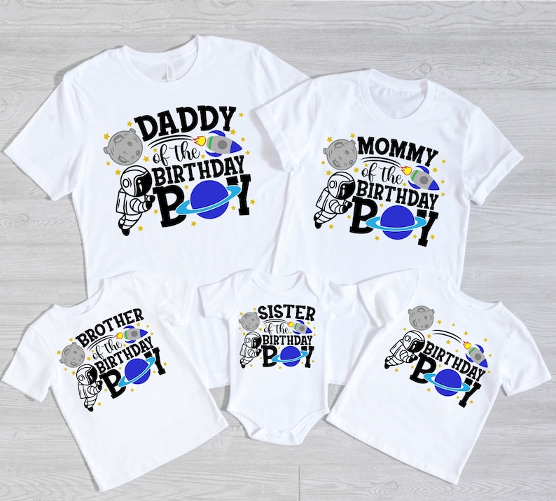 May include: Set of five white t-shirts with astronaut and space-themed designs. The shirts say "Daddy of the Birthday Boy", "Mommy of the Birthday Boy", "Brother of the Birthday Boy", "Sister of the Birthday Boy", and "Birthday Boy".