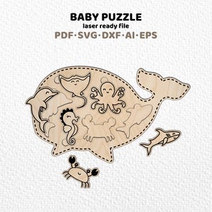 May include: A wooden baby puzzle shaped like a whale, with laser-cut sea creatures including a dolphin, stingray, octopus, seahorse, crab, and shark. The puzzle is designed for young children. The text "BABY PUZZLE" is at the top.