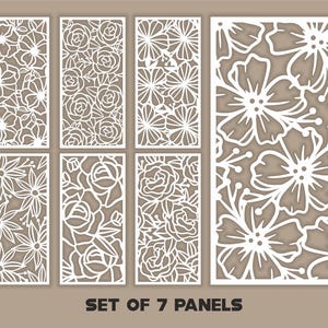 May include: Set of seven white laser-cut decorative panels featuring floral designs. The panels showcase various flower and leaf patterns, including roses and other blooms. The text "SET OF 7 PANELS" is displayed at the bottom.