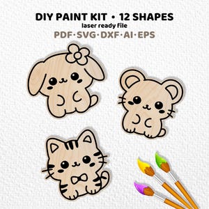 May include: DIY paint kit with 12 shapes, laser ready file, PDF, SVG, DXF, AI, EPS. Includes three light wood animal cutouts: a dog with a flower, a mouse, and a striped cat, alongside three paintbrushes with yellow, green, and purple bristles.