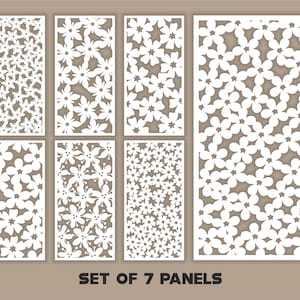 May include: Set of seven white floral patterned panels. The panels feature a repeating flower design cut out of the white material. The text "SET OF 7 PANELS" is displayed at the bottom of the image.