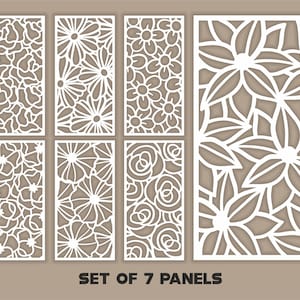 Puede incluir: Conjunto de siete paneles decorativos blancos con intrincados diseños florales recortados. Los paneles presentan varios patrones de flores, incluyendo margaritas, rosas y arreglos florales abstractos. El texto "SET OF 7 PANELS" se muestra en la parte inferior.