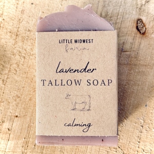 May include: A bar of lavender tallow soap with a brown paper label that reads "Little Midwest Farm", "lavender tallow soap", and "calming".