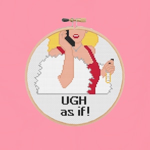 May include: A white embroidery hoop with a cross-stitch design of a woman with blonde hair on the phone. The woman is wearing a red dress and a white fur collar. The text "UGH as if!" is below the image.