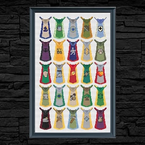 May include: Framed cross-stitch art featuring a collection of colorful capes, each with a unique emblem. The capes are in various colors, including blue, green, yellow, and red, with symbols like a tree, heart, and lightning bolt. The artwork is displayed against a dark brick wall.