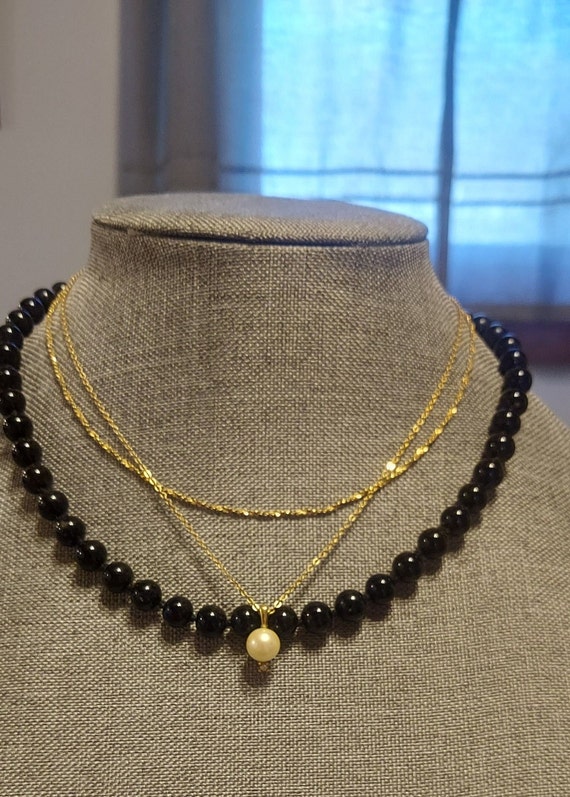 3 necklaces marked Monte. Black pearl look,goldton