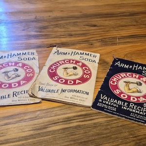 May include: Three vintage "Arm & Hammer Soda" recipe books. The covers feature a circular logo with a weightlifter and the text "Church & Co's Soda". The books are in varying shades of blue and cream, with red and black text.