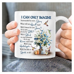 May include: White ceramic mug featuring a floral design and hummingbirds. The mug displays the text "I Can Only Imagine" and a poem about faith and hope.