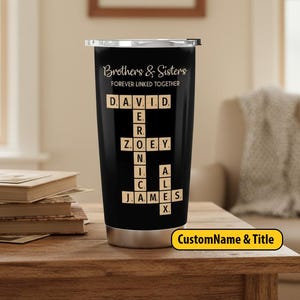 May include: A black stainless steel travel mug with a silver rim and lid. The mug features the text "Brothers & Sisters Forever Linked Together" and names in a crossword design. A yellow sticker at the bottom right says "CustomName & Title".