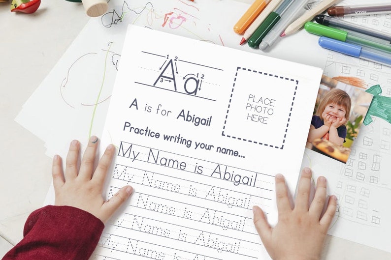 May include: A printable worksheet for practicing writing the name Abigail. The worksheet includes a tracing guide for the letter A, a space to write the name multiple times, and a place to add a photo. The text "A is for Abigail" and "Practice writing your name..." is included.
