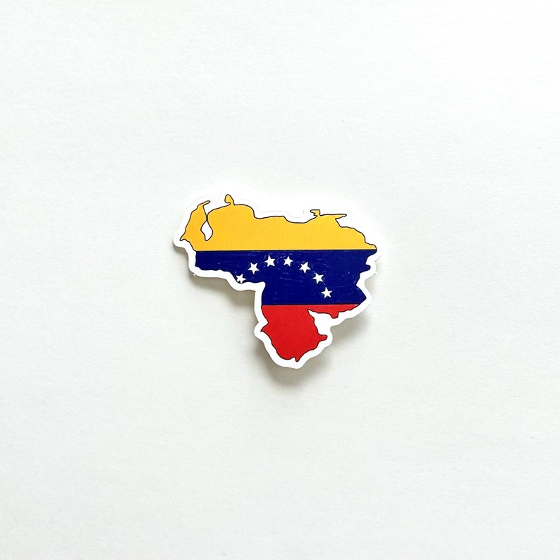 May include: A sticker of the outline of Venezuela with the Venezuelan flag colours: yellow, blue, and red. The flag has seven white stars in an arc.