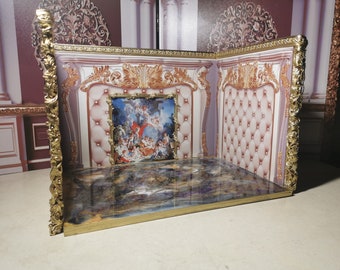 May include: A miniature dollhouse room set with gold trim and a white and gold patterned wallpaper. The room features a white tufted headboard, a framed painting, and a blue and gold patterned floor.