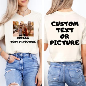 May include: A cream-coloured t-shirt featuring a family photograph on the front. The image depicts a family of four. Below the photo is the text "CUSTOM TEXT OR PICTURE". The back of the shirt displays the text "CUSTOM TEXT OR PICTURE".